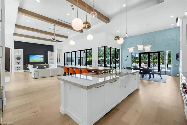a view of a living room and kitchen with a large window