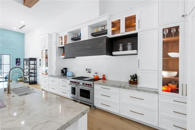 a kitchen with stainless steel appliances a stove a sink and a microwave
