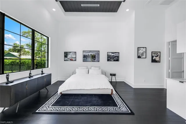 a room with a bed and a large window