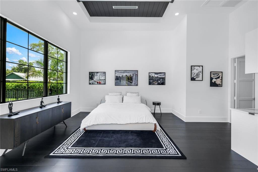 6677 Hunters Road Naples, FL 34109 - Photo 32 of 50 a room with a bed and a large window