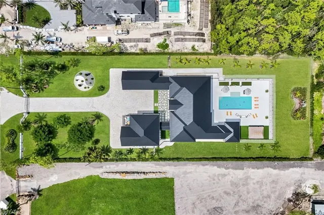 an aerial view of a house with a yard and outdoor seating