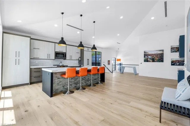 a large kitchen with stainless steel appliances kitchen island granite countertop a large center island and a stove top oven