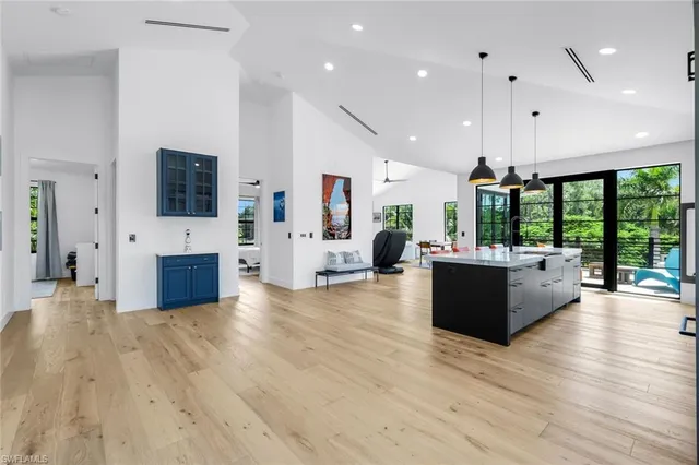a living room with furniture a flat screen tv and a floor to ceiling window