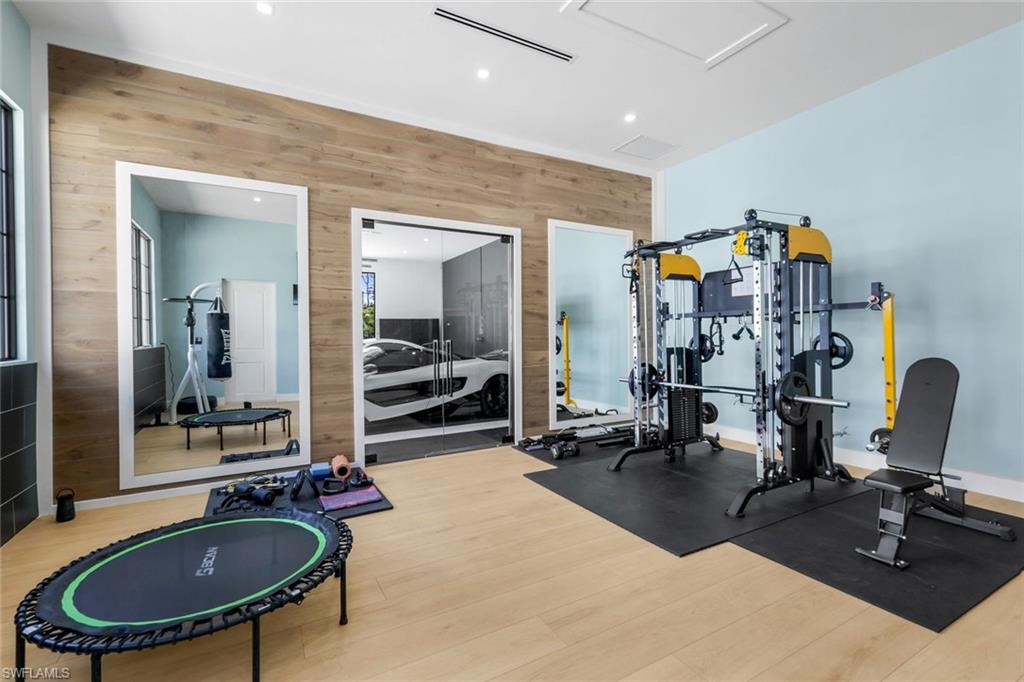 6677 Hunters Road Naples, FL 34109 - Photo 46 of 50 a gym room with lots of gym equipment