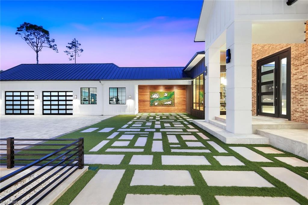 6677 Hunters Road Naples, FL 34109 - Photo 6 of 50 a front view of a building