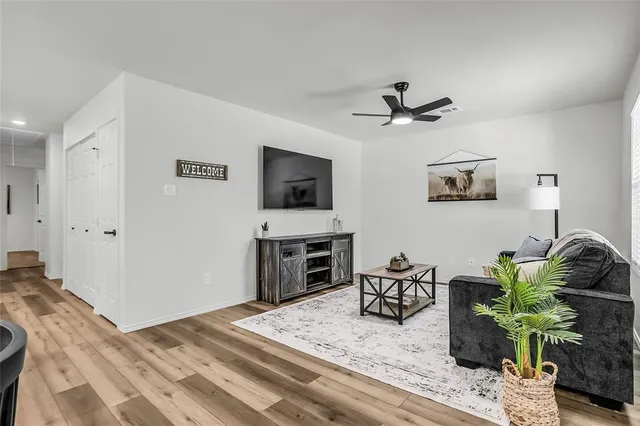 a bedroom with furniture and a flat screen tv
