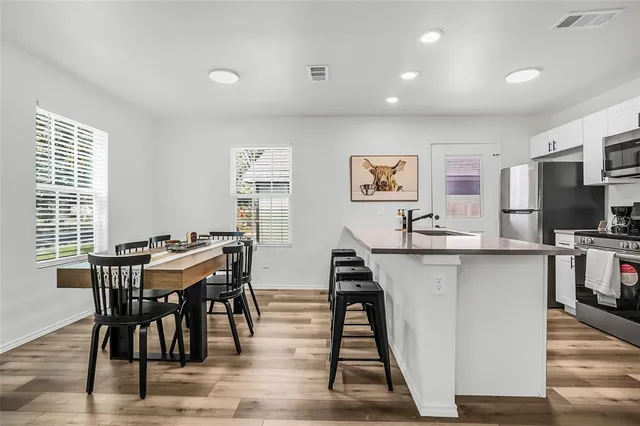a view of a dining room with furniture and wooden floor