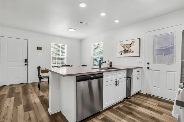 a spacious bathroom with a granite countertop sink a window and a mirror