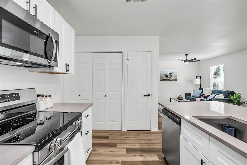 308 South 3rd Street Bonham, TX 75418 - Photo 15 of 19 a kitchen with stainless steel appliances a sink stove and cabinets