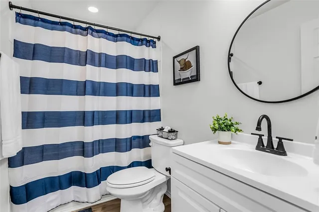 a bathroom with a sink a toilet and a mirror