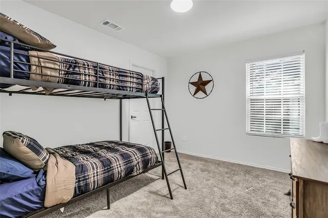 a bedroom with a bed and window