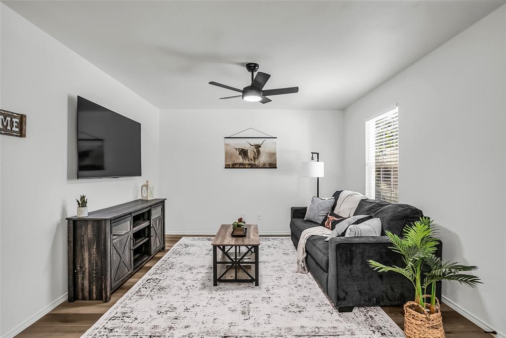 308 South 3rd Street Bonham, TX 75418 - Photo 9 of 19 a living room with furniture and a flat screen tv