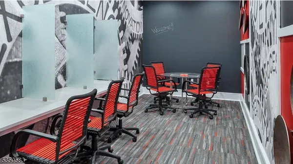 a view of a white house with a large windows next to a road