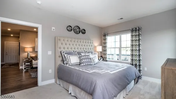 a bedroom with a bed and a large window