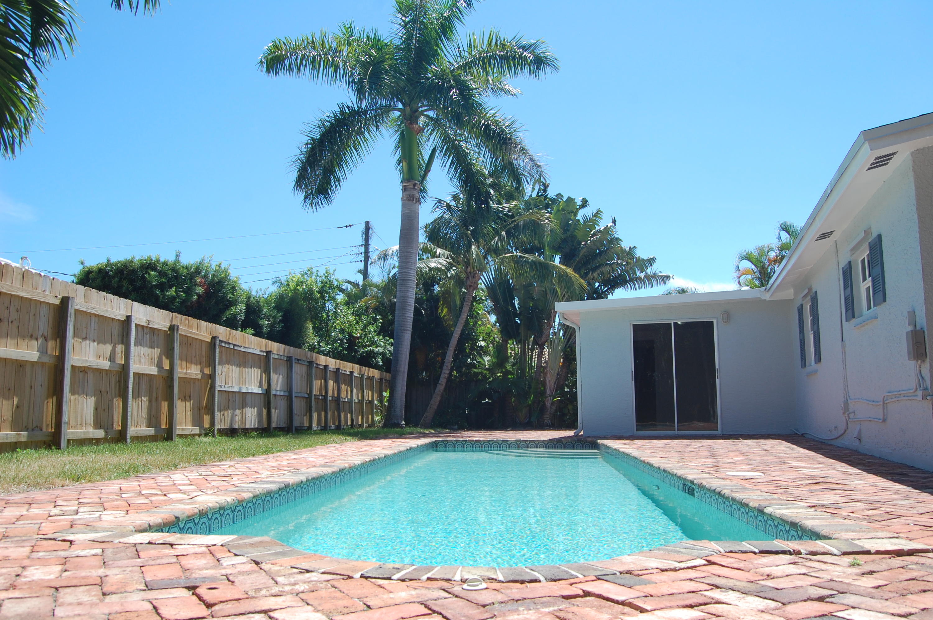 1150 Southwest 4th Avenue Boca Raton, FL 33432 - Photo 3 of 14 a backyard of a house with palm trees