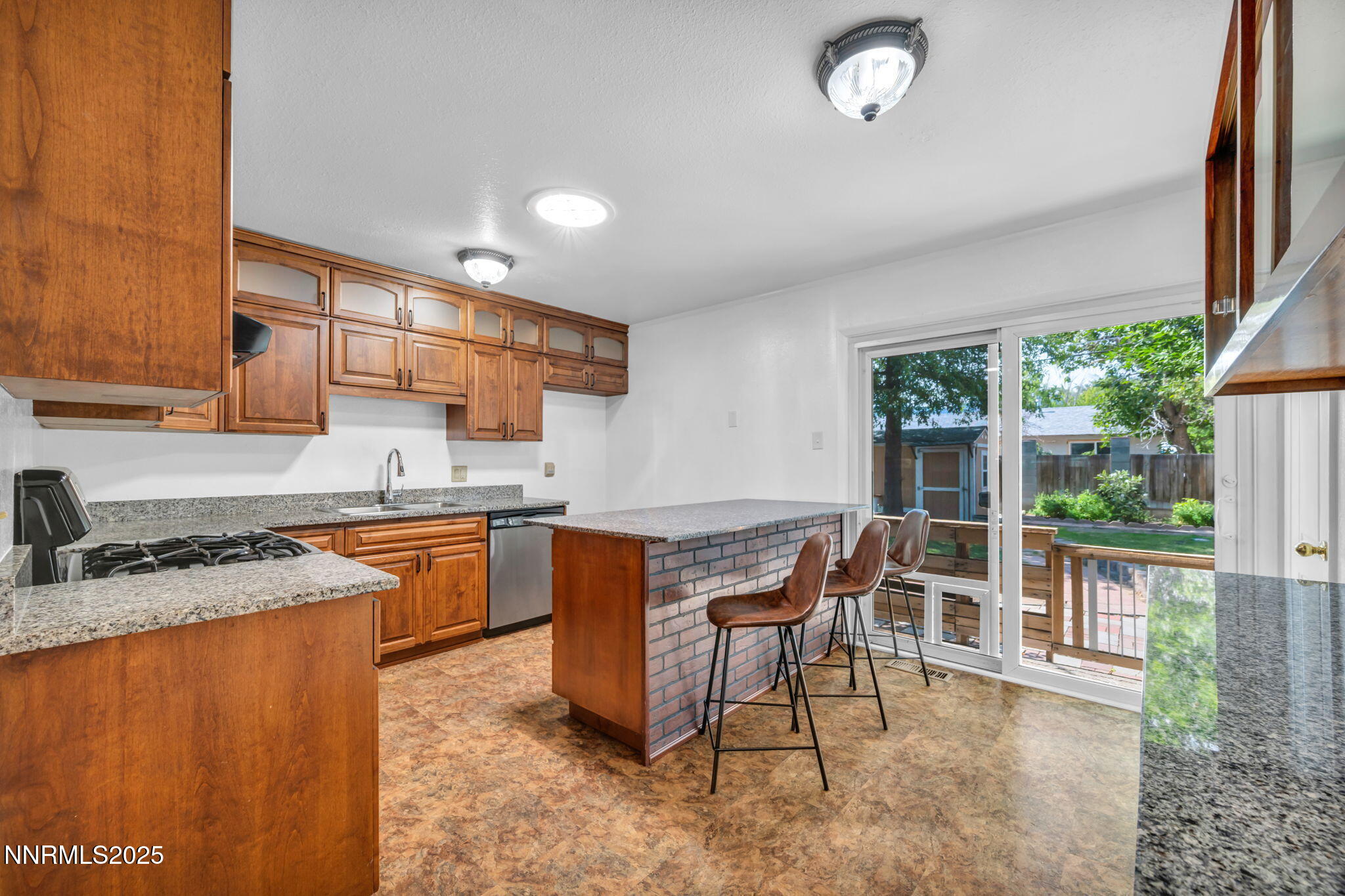 3570 West 7th Street Reno, NV 89503 - Photo 20 of 45 a kitchen with stainless steel appliances granite countertop a stove a sink and a microwave