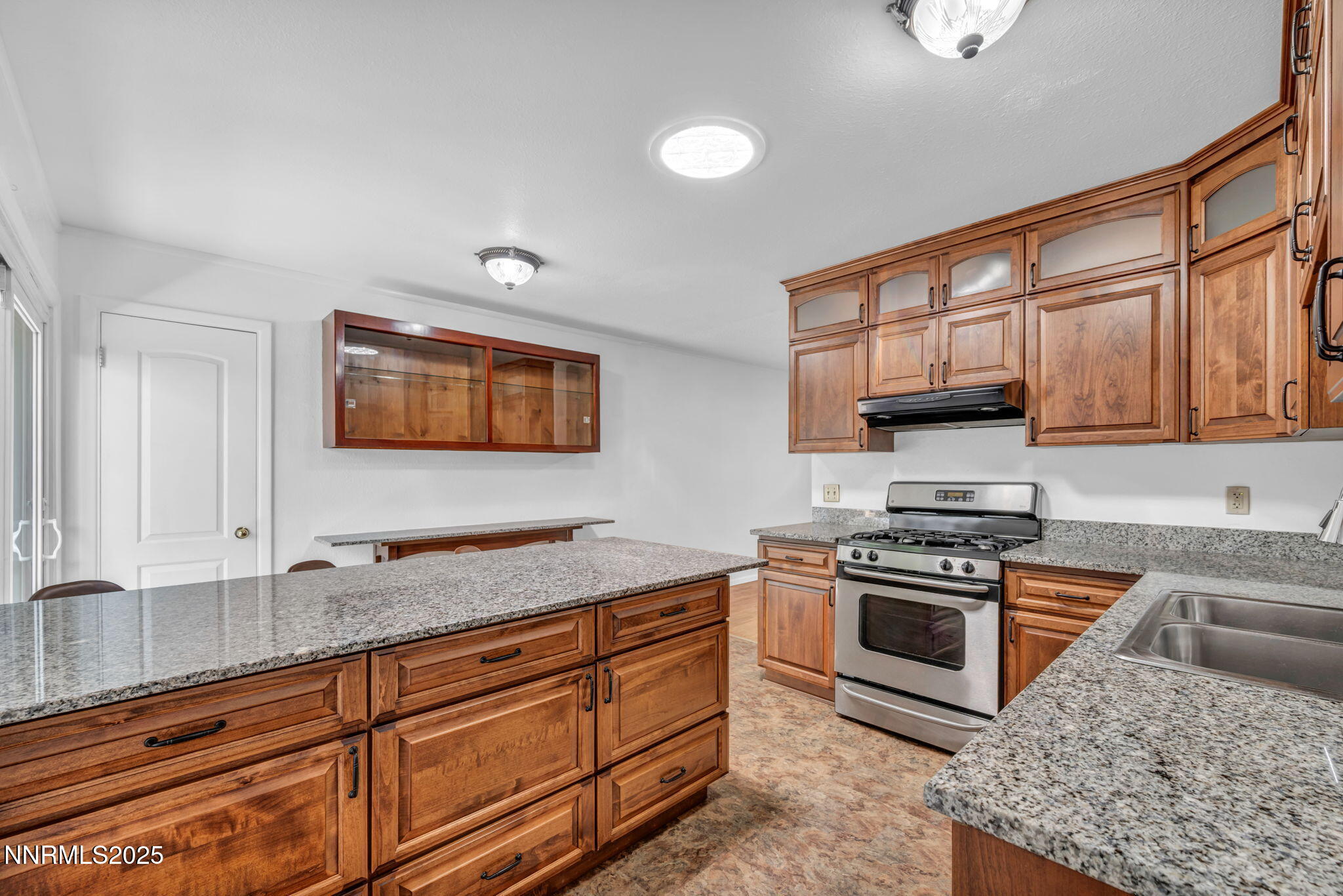 3570 West 7th Street Reno, NV 89503 - Photo 21 of 45 a kitchen with stainless steel appliances granite countertop a stove a sink and a microwave