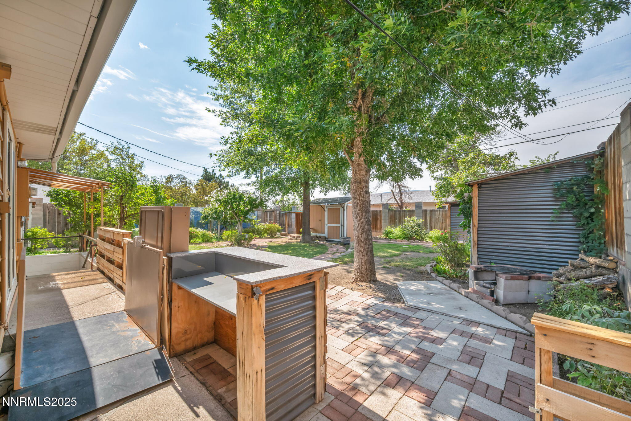 3570 West 7th Street Reno, NV 89503 - Photo 37 of 45 a view of a patio with table and chairs potted plants and large tree