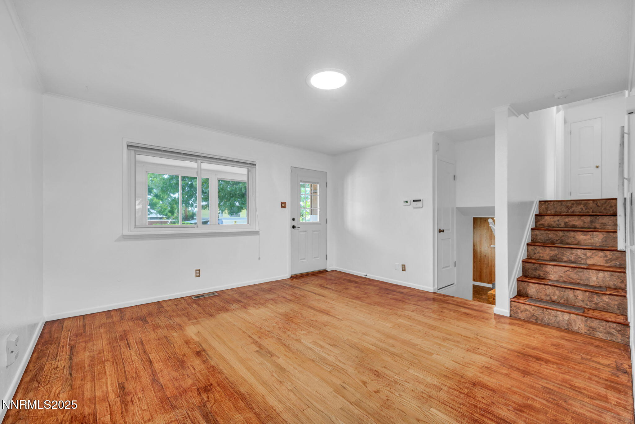 3570 West 7th Street Reno, NV 89503 - Photo 10 of 45 an empty room with wooden floor and stairs