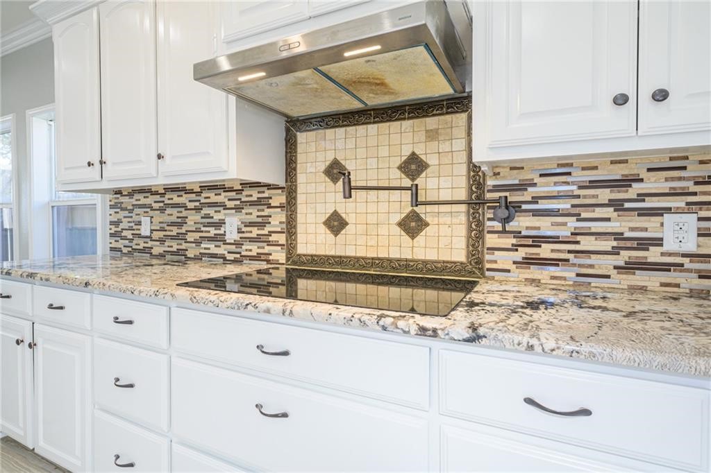 120 Sandollar Circle Fulton, TX 78382 - Photo 13 of 39 a kitchen with granite countertop white cabinets and sink