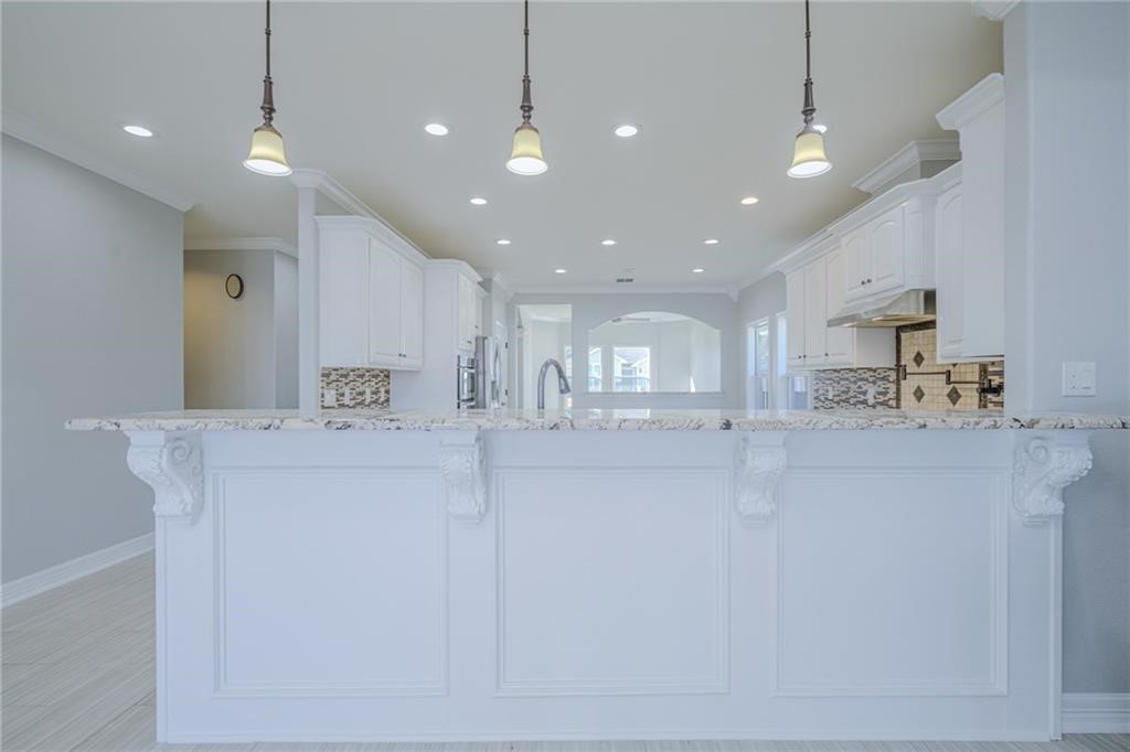 120 Sandollar Circle Fulton, TX 78382 - Photo 15 of 39 a view of a kitchen with kitchen island a sink stainless steel appliances and a counter top space