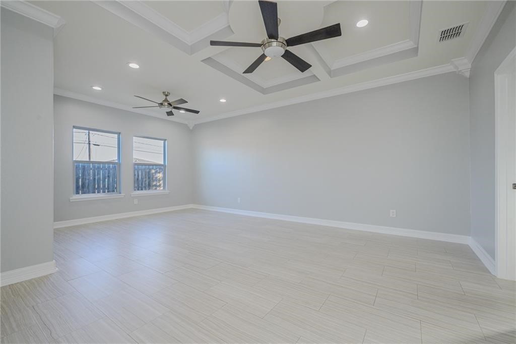 120 Sandollar Circle Fulton, TX 78382 - Photo 18 of 39 an empty room with wooden floor fan and windows