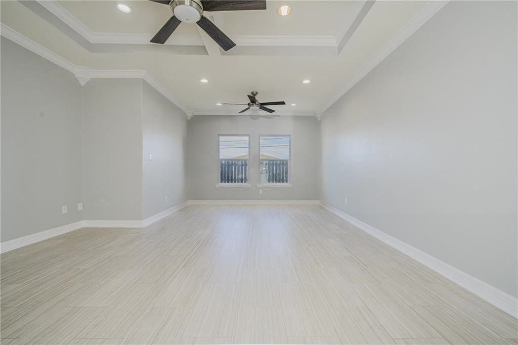 120 Sandollar Circle Fulton, TX 78382 - Photo 20 of 39 an empty room with wooden floor ceiling fan and windows