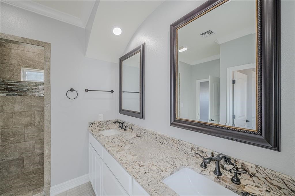 120 Sandollar Circle Fulton, TX 78382 - Photo 23 of 39 a bathroom with a granite countertop sink and a mirror