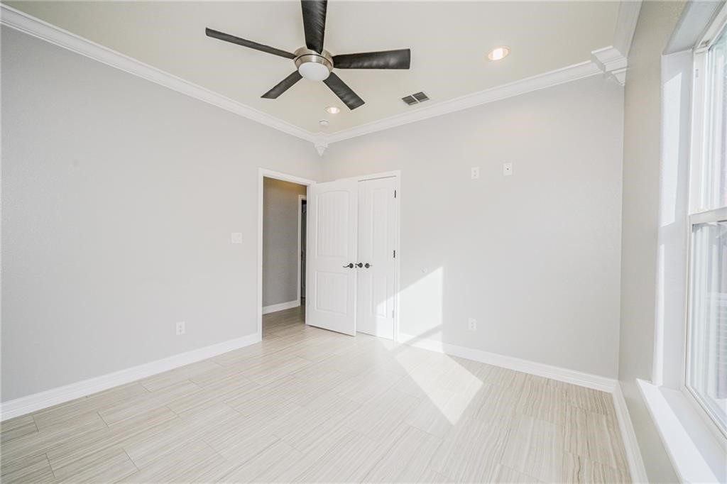 120 Sandollar Circle Fulton, TX 78382 - Photo 32 of 39 an empty room with a white cabinet and a ceiling fan
