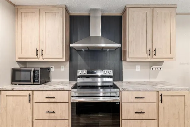 a kitchen with a sink a refrigerator and chairs