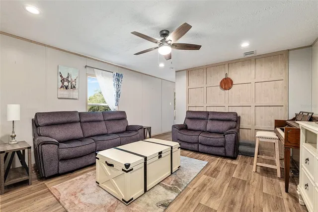 a living room with furniture and kitchen view