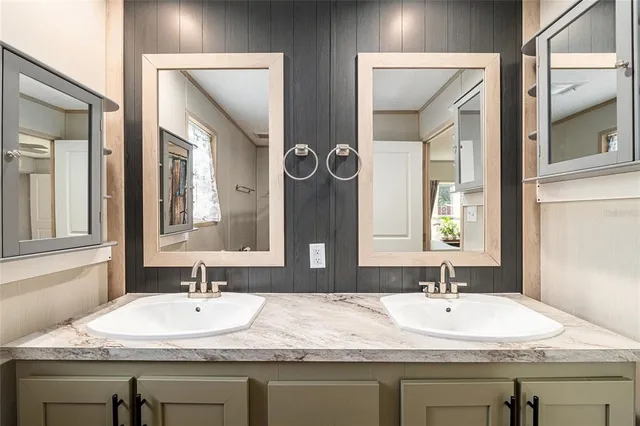 a bathroom with a tub sink and mirror