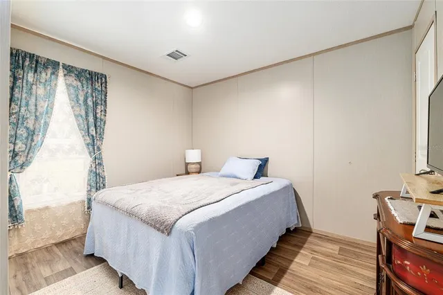 a bathroom with a sink a toilet a mirror and shower curtain