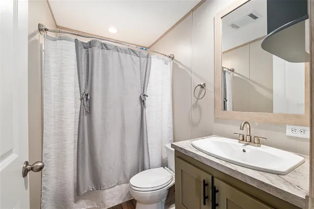 a view of a room with wooden floor and furniture