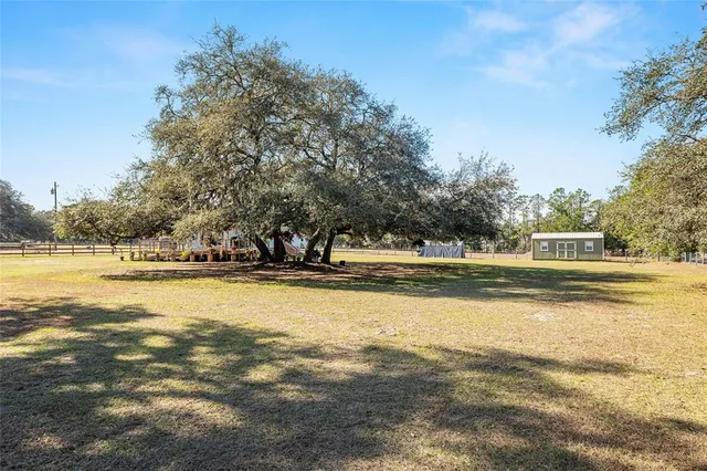 a view of a house with a yard and garage