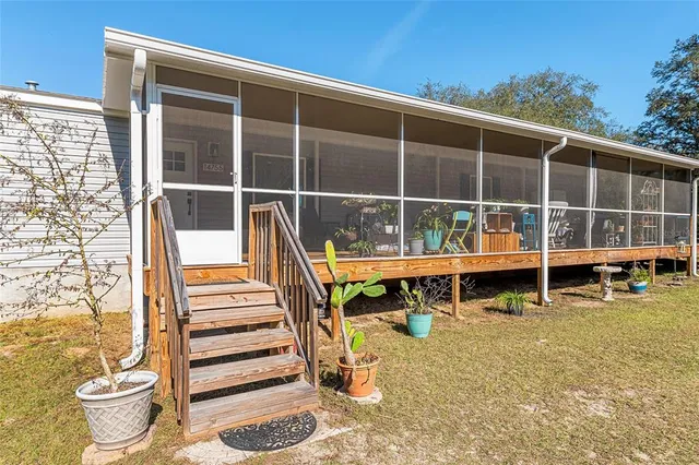 a view of swimming pool with outdoor seating and plants