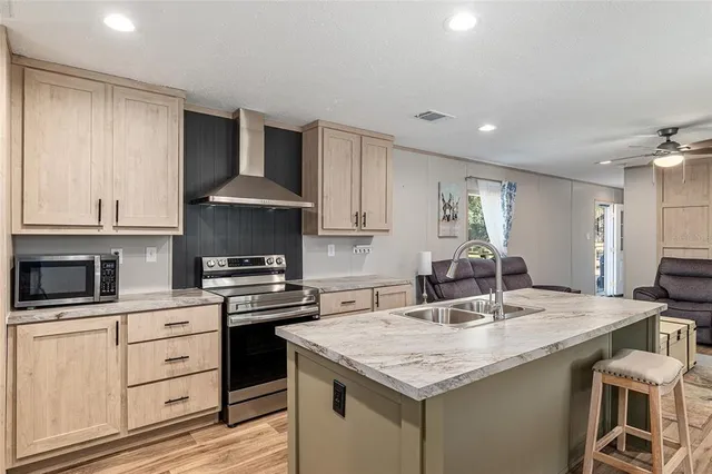 a kitchen with a sink stove and cabinets