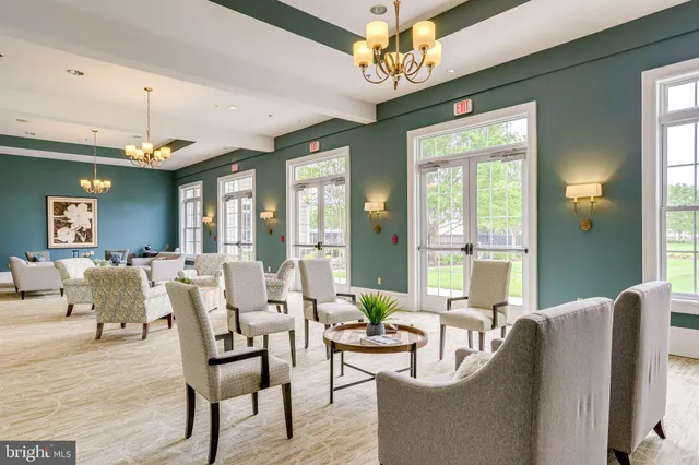 a living room with furniture a chandelier and a chandelier