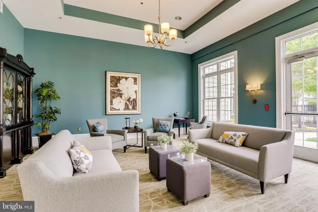 a living room with furniture and a chandelier