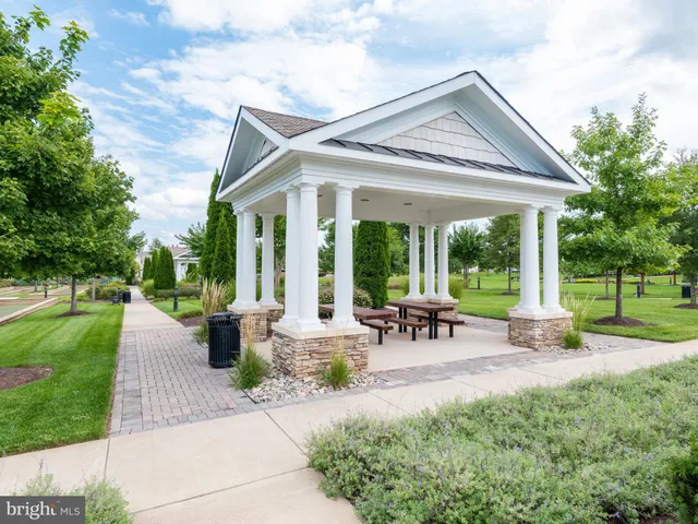a view of a house with backyard sitting area and garden