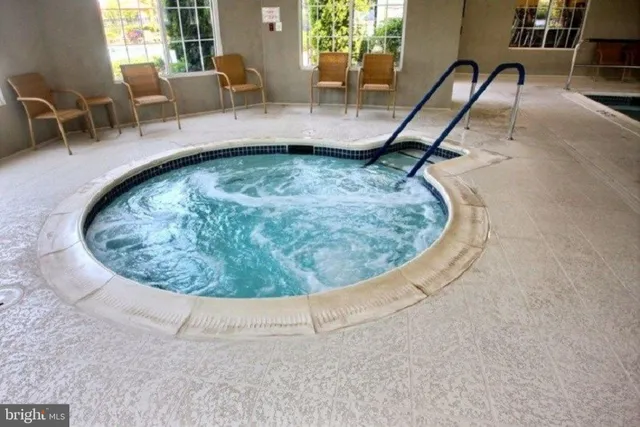 a view of a swimming pool with outdoor seating