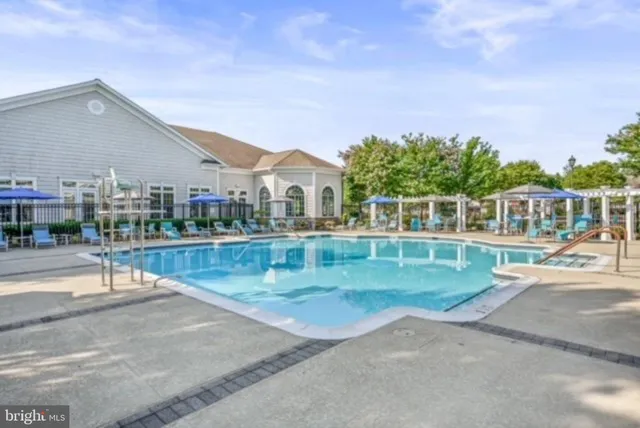 a view of swimming pool in front of residential houses
