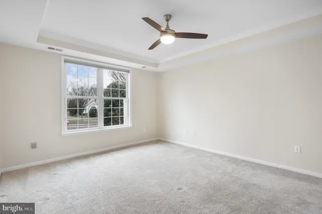 a view of a livingroom with a ceiling fan and window