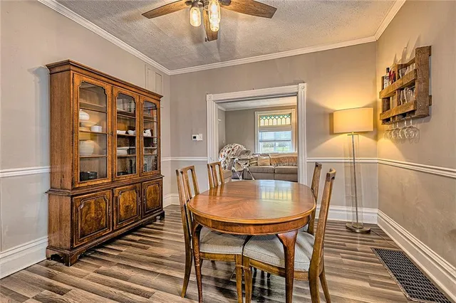 a dining room with furniture and wooden floor