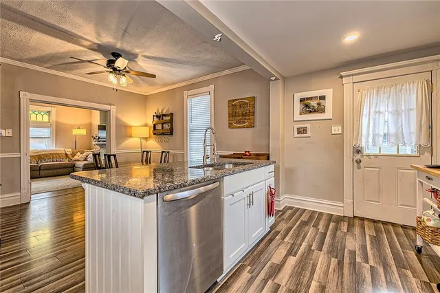 a spacious bathroom with a granite countertop sink a mirror and a shower