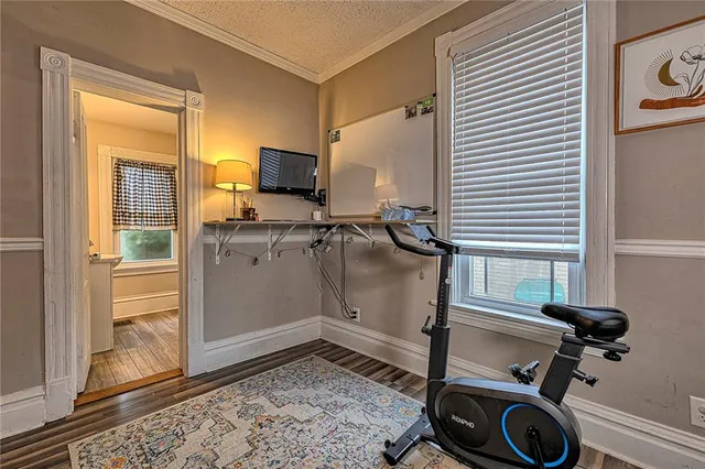 a view of a workspace with furniture and a window