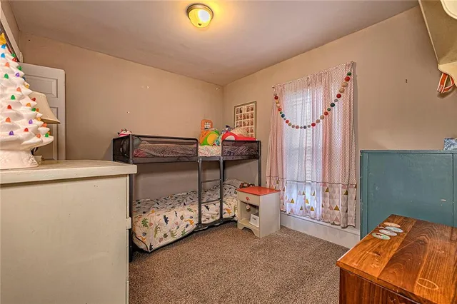 a bedroom with a bed and a lamp