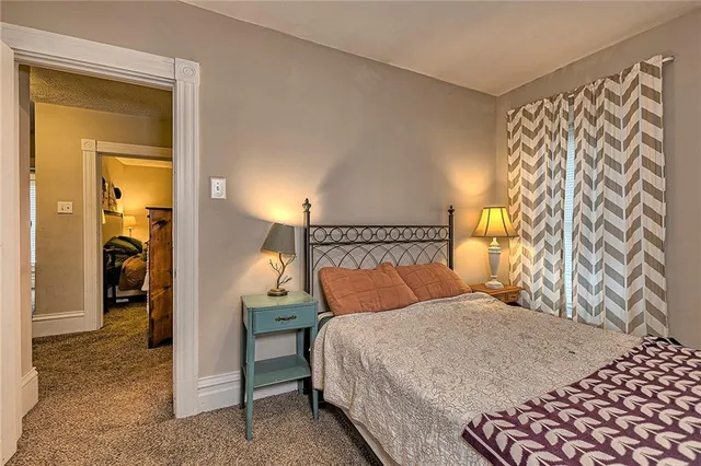 a bedroom with a bed and a chair