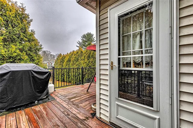 a backyard of a house with wooden floor outdoor seating and trees
