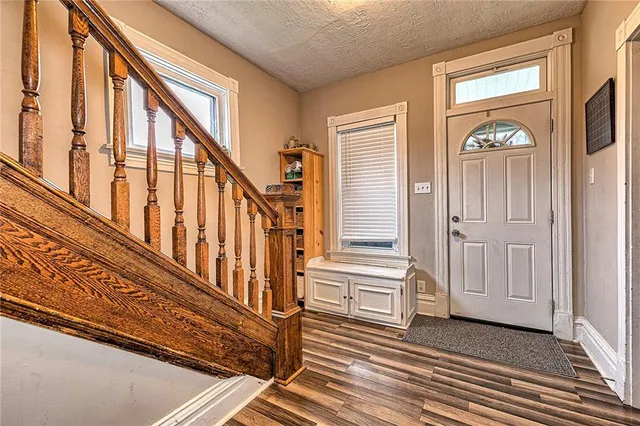 a view of an entryway with wooden floor and stairs
